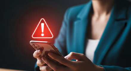Businesswoman holding smartphone with glowing red warning icon, concept of cybersecurity alert, system error, or urgent mobile notification
