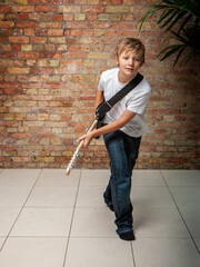 Family Life, Guitar Hero. A young boy showing off his rock ambitions. From a series of related...