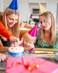 Family Life, Birthday Cake. A young family celebrating the youngest daughter's third birthday. From...
