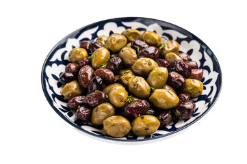 Mix olives with herbs and oil in plate isolated on white background.