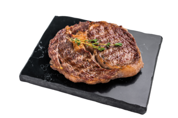 Grilled Rib eye steak with herbs and spice on marble  board, prime beef meat isolated on white background