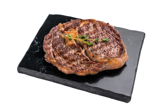 Grilled Rib eye steak with herbs and spice on marble  board, prime beef meat isolated on white background