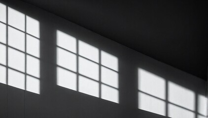 Geometric architectural shadows forming abstract monochrome patterns with high contrast.