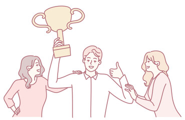 A joyful celebration unfolds as one person proudly holds a trophy with others cheering and supporting enthusiastically