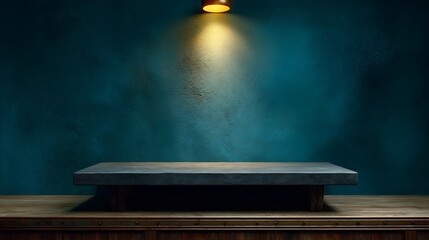 Illuminated display platform against textured teal wall