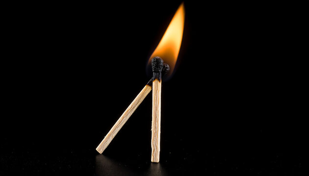 A close-up photo of matchsticks burned at both ends, with a small flame and a wisp of smoke, set against a dark background, symbolizing exhaustion