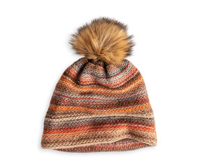 Top view of single cozy casual winter or autumn knit pom-pom beanie hat of brown orange colours made of warm wool woven fabric textile isolated on white background used as accessory for cold weather
