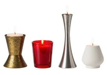 Four decorative candles in different holders are burning brightly on a