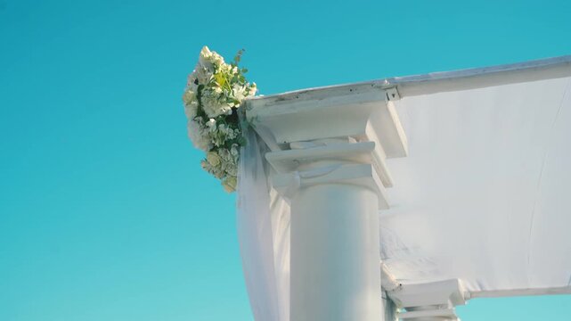 A beautiful white canopy with white flowers on the wedding day. High quality FullHD footage