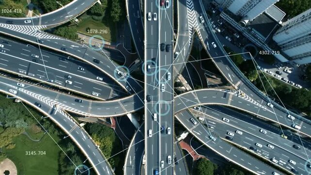 Aerial view of a complex highway interchange with connected car technology overlayed on the roads