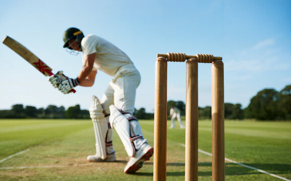Cricket batsman at the crease with bat and wickets during a match.