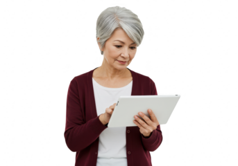 An elegant senior asian woman uses a tablet browsing content against a