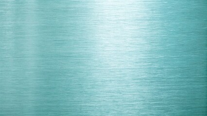 A light blue metallic background showcases a smooth brushed texture with subtle horizontal lines...