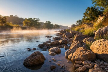 River steam rises on rocky shoreline at sunrise. Vacation, nature background use