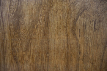 Dark brown wood grain texture background. A natural wooden surface or floorboard with a vertical...
