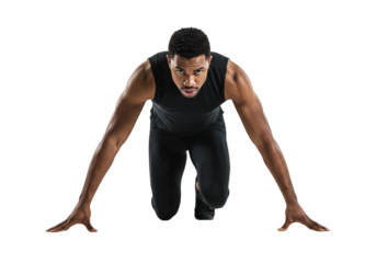 An athletic man is in a starting position for a sprint focused and ready on a
