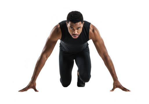 An athletic man is in a starting position for a sprint focused and ready on a