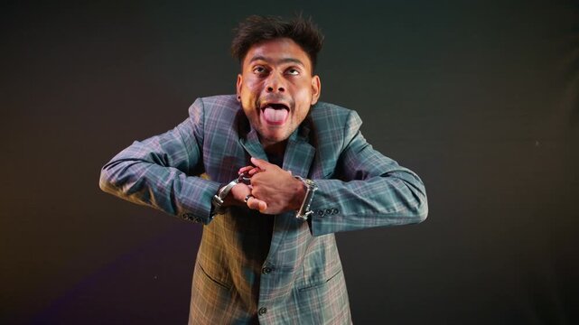 Entertainer makes faces while removing metal cuff