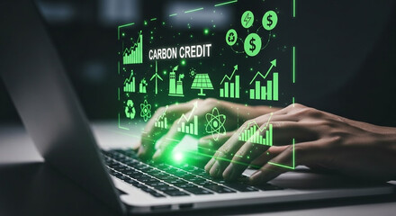 Person typing on a laptop with a glowing green financial data interface