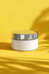 White cosmetic jar with metallic lid on bright yellow background, sunlit shadows