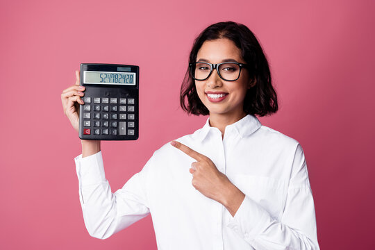 Confident businesswoman with calculator demonstrating professional precision on pink background - Powered by Adobe