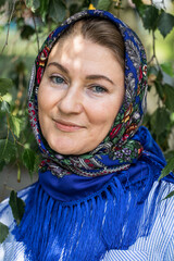 Beautiful woman in a traditional headscarf, summer outdoor