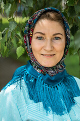 Beautiful woman in a traditional headscarf, summer outdoor