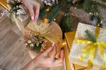 Female Hands Decorating Christmas Gift