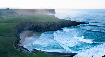 Sunset view from a drone of Antuerta Beach in Ajo, in the municipality of Bareyo, in the autonomous community of Cantabria, Spain. Europe