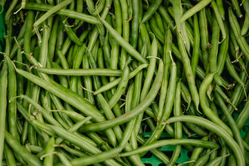 Fresh greens at small local urban market. Organic produce on sale at outdoor farmer market. Selling fresh crops and veggies harvest. European urban setting. Close up. Part of the series.