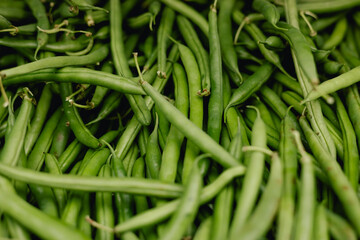Fresh greens at small local urban market. Organic produce on sale at outdoor farmer market. Selling fresh crops and veggies harvest. European urban setting. Close up. Part of the series.