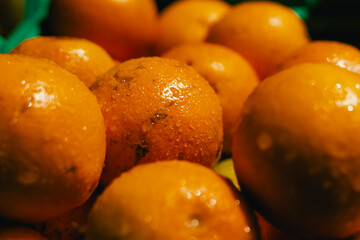 Close-up of oranges and lemons into a bag at a local market. Organic produce on sale at outdoor farmer market. Selling fresh crops and veggies harvest. Close up. Part of the series