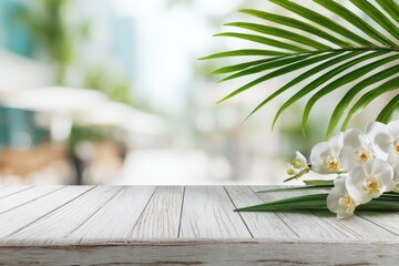 White wooden table with orchids and palm leaf, out-of-focus city background