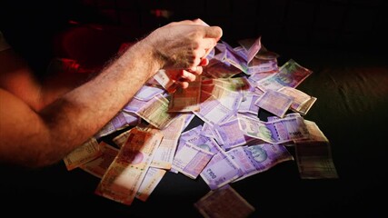 Banknotes of 500 are aligned with remaining money scattered