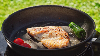 fresh fish fillet on hot pan