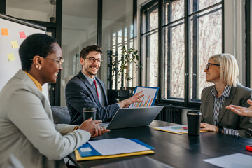Business team analyzing charts and statistics during meeting