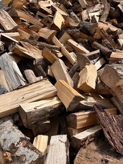 chopped firewood stacked in a pile
