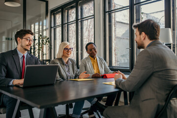 Managers interviewing a candidate for a job position in a modern office