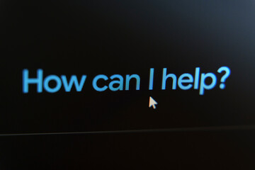 Mouse cursor hovering over an AI assistant prompt How can I help on a dark virtual assistant interface