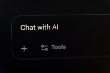 Chat with AI prompt displayed on a dark digital interface with plus and tools icons
