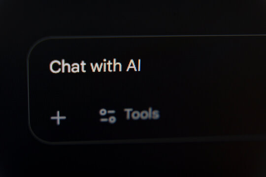 Chat with AI prompt displayed on a dark digital interface with plus and tools icons
