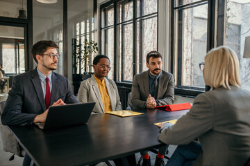 Human resources manager interviewing three candidates during a job interview