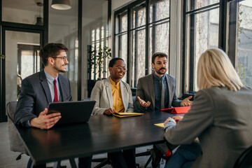 Managers interviewing a job candidate during a meeting in the office