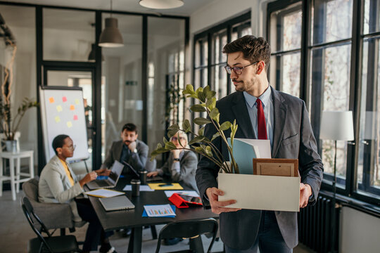 Businessman leaving office after getting fired from job