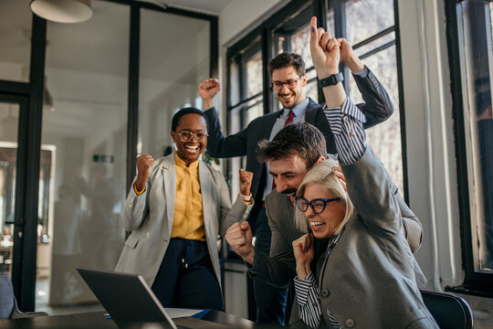Excited business team celebrating success in the office