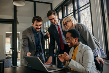 Business people working together on laptop in office meeting room