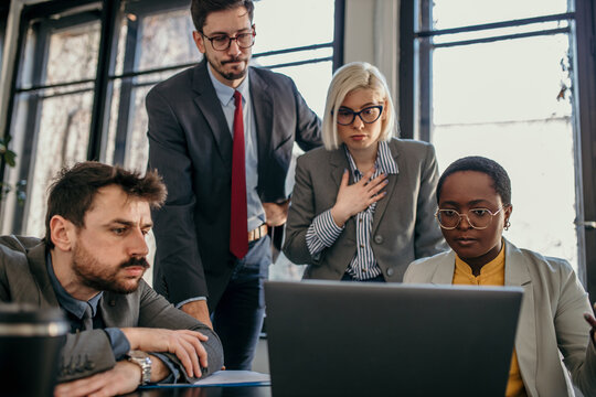 Business people having a serious meeting using laptop in the office