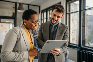 Business colleagues collaborating on digital tablet in office
