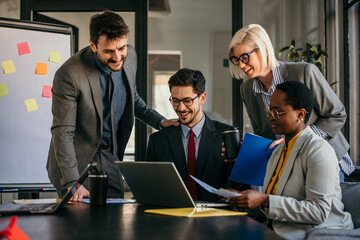 Business people working together on a project using laptop in the office