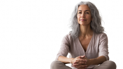 Calm woman meditating indoors with a peaceful expression, sitting cross-legged on the floor in a bright room during daylight on transparent background